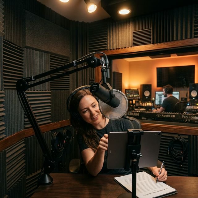 A professional audiobook recording studio showing a condenser microphone